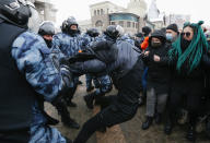 Police officers detain a man during a protest against the jailing of opposition leader Alexei Navalny in Moscow, Russia, Sunday, Jan. 31, 2021. Thousands of people took to the streets Sunday across Russia to demand the release of jailed opposition leader Alexei Navalny, keeping up the wave of nationwide protests that have rattled the Kremlin. Hundreds were detained by police. (AP Photo/Alexander Zemlianichenko)