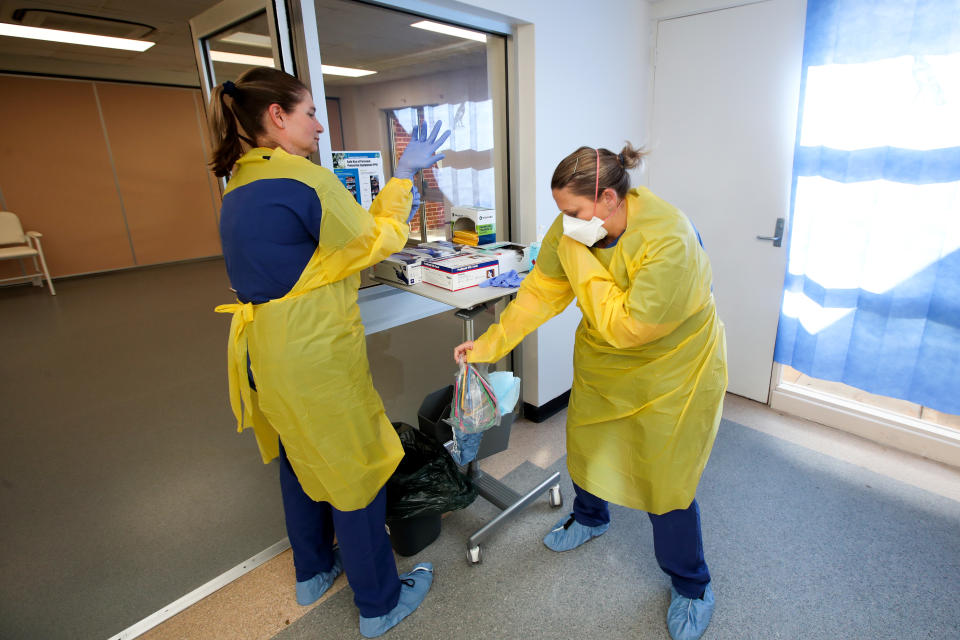 Nurses Tamzin Ingram and Skye Haagmans prepare for patients at the new Covid-19 Clinic at the Mount Barker Hospital in Adelaide. Source: AAP