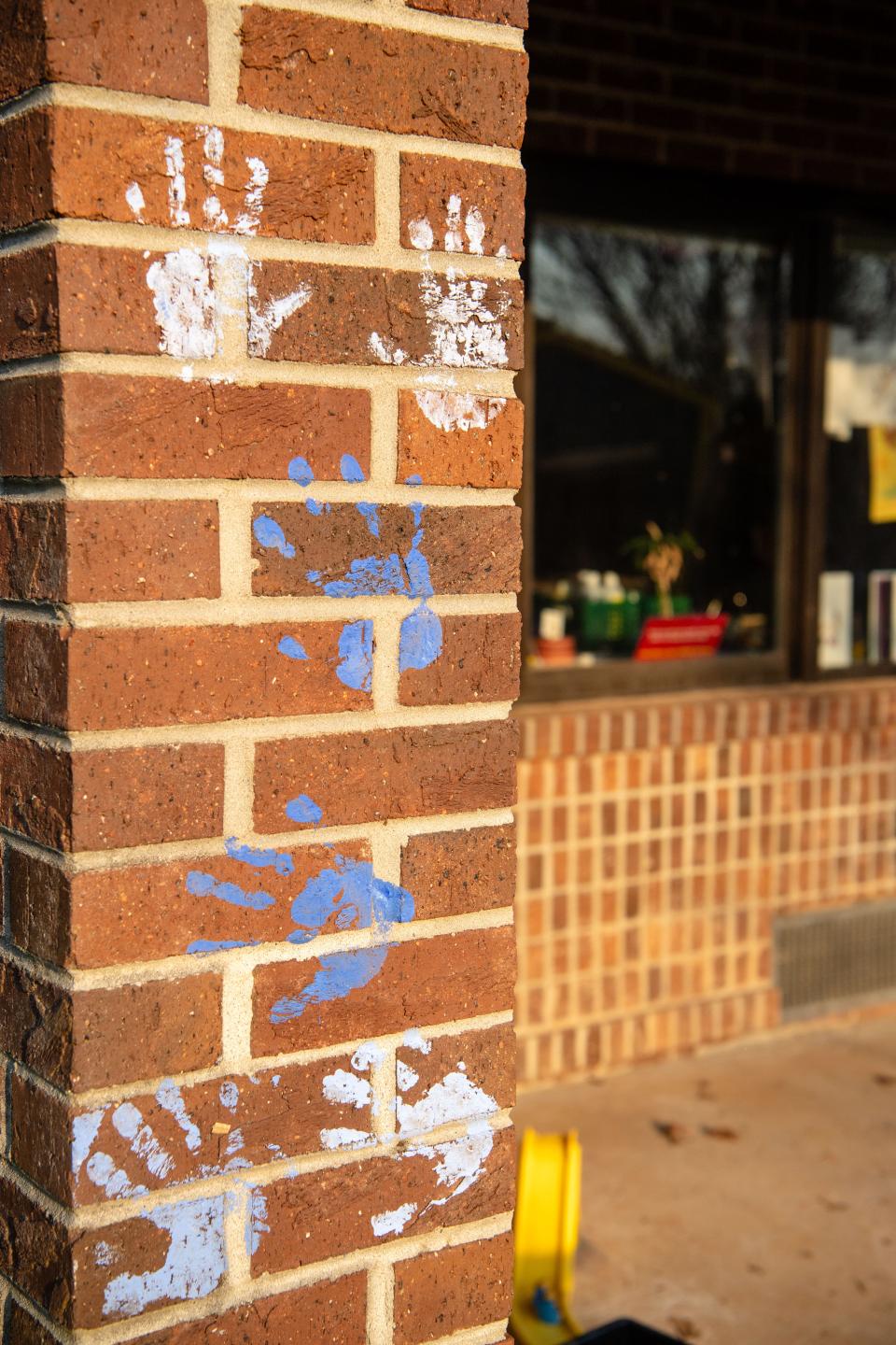 Children’s handprints are seen on the wall of Lucy S. Herring Elementary, March 14, 2024.