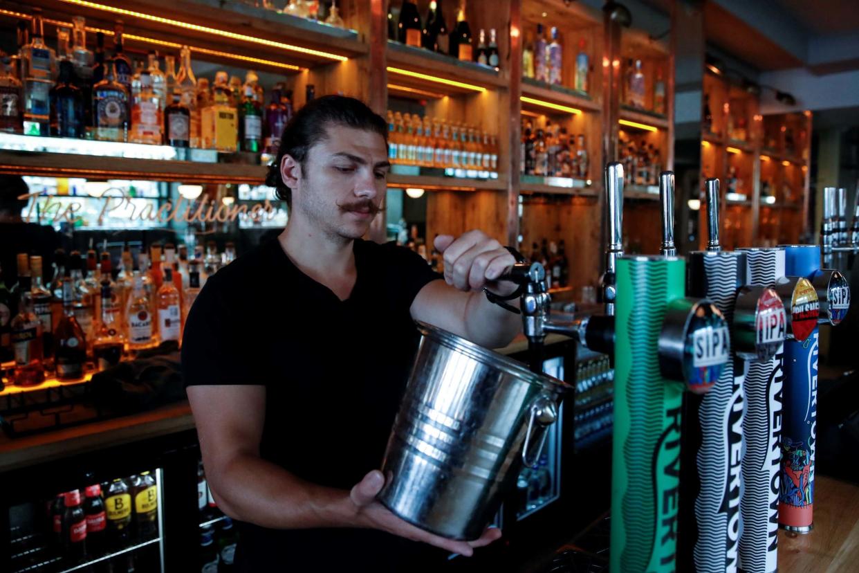 A Practicioner pub employee prepares for the reopening of pubs in Hertford: REUTERS