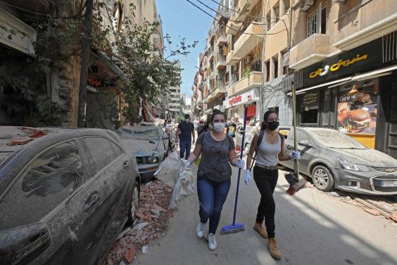 Volunteers arrive on Gouraud street in the Gemmayze neighbourhood of Beirut to clear debris (Anwar Amro/AFP)