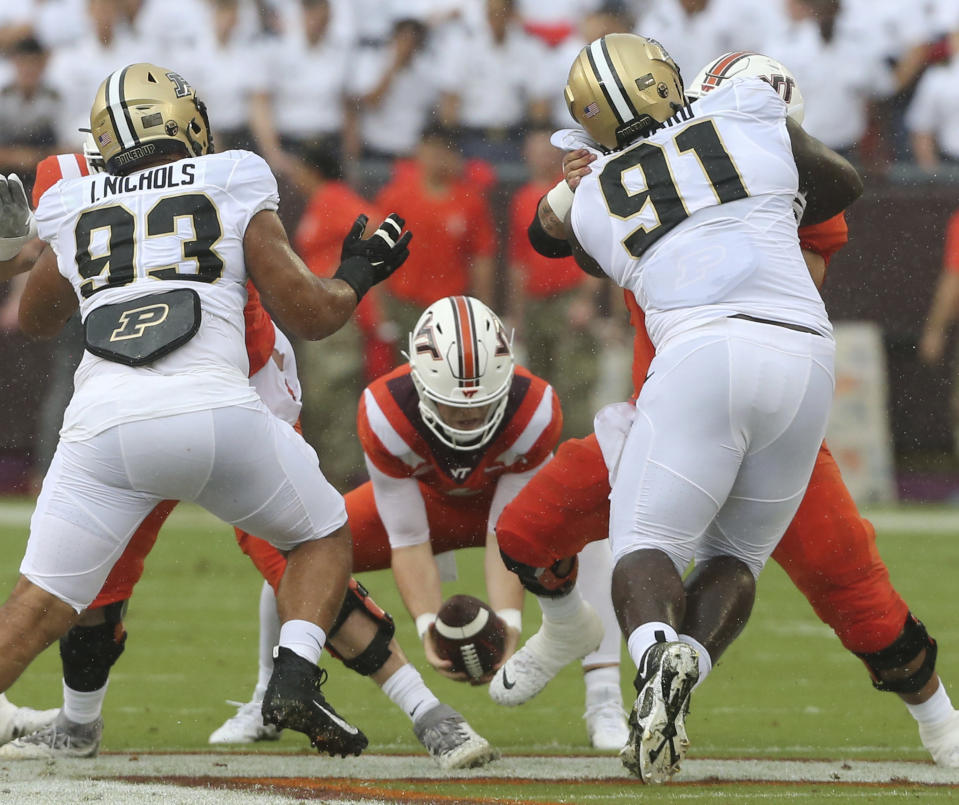 Virginia Tech quarterback Grant Wells (6) collects a dropped snap in the first half of an NCAA college football game against Purdue in Blacksburg, Va., Saturday, Sept. 9 2023. (Matt Gentry/The Roanoke Times via AP)