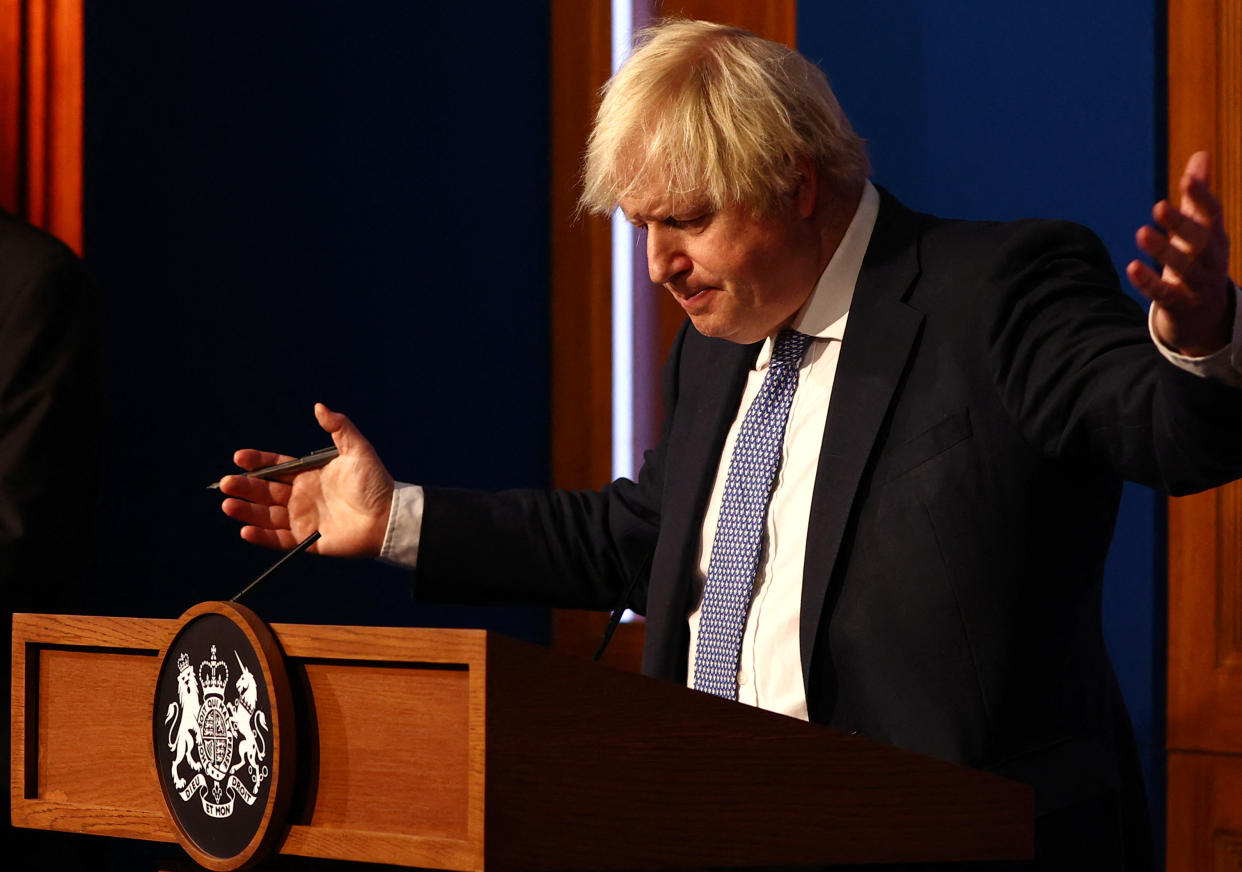 TOPSHOT - Britain's Prime Minister Boris Johnson gestures during a press conference for the latest Covid-19 update in the Downing Street briefing room in central London on December 8, 2021. - The UK government is reintroducing Covid-19 restrictions due to the Omicron variant. (Photo by Adrian DENNIS / POOL / AFP) (Photo by ADRIAN DENNIS/POOL/AFP via Getty Images)