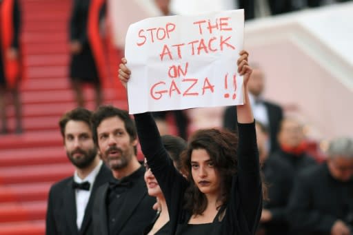 French-Lebanese actress Manal Issa, starring in Syrian director Gaya Jiji's first film "My Favourite Fabric", took her anti-war protest to the Cannes red carpet as she held up a sign reading "Stop the Attack on Gaza"