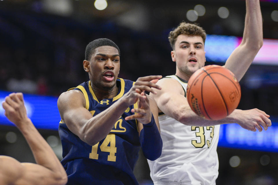 Notre Dame forward Kebba Njie (14) passes the ball past Wake Forest center Matthew Marsh (33) during the first half of an Atlantic Coast Conference second round NCAA college basketball tournament game Wednesday, March 13, 2024, in Washington. (AP Photo/Nick Wass)