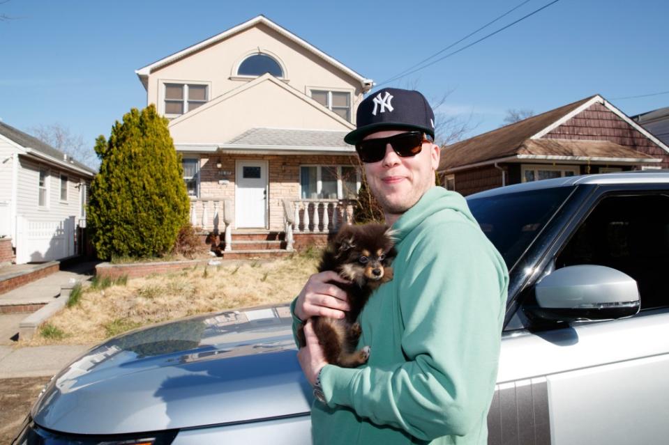 Brian Rodriguez with his dog Larry, outside of the home where he has been accused of being a squatter. He insists that he is not a squatter. Brian Zak/NY Post