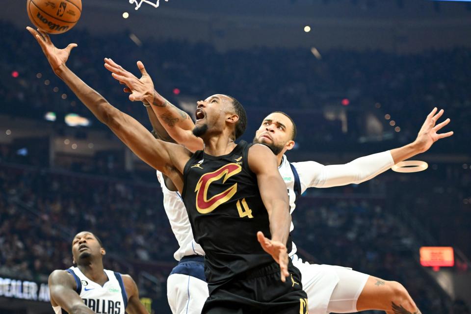 Cleveland Cavaliers forward Evan Mobley (4) shoots against Dallas Mavericks center JaVale McGee during the first half of an NBA basketball game, Saturday, Dec. 17, 2022, in Cleveland. (AP Photo/Nick Cammett)