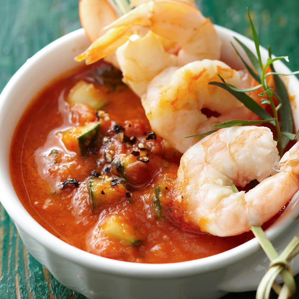 <p>Traditional gazpacho is made with raw tomatoes and is a delicious cold soup for warm weather. In this recipe, we've tweaked it a bit, by roasting the tomatoes first, blending the roasted vegetables with some crusty country bread to thicken it, and serving it with chilled shrimp. <a href="https://www.eatingwell.com/recipe/269680/roasted-tomato-gazpacho-with-shrimp/" rel="nofollow noopener" target="_blank" data-ylk="slk:View Recipe;elm:context_link;itc:0;sec:content-canvas" class="link ">View Recipe</a></p>