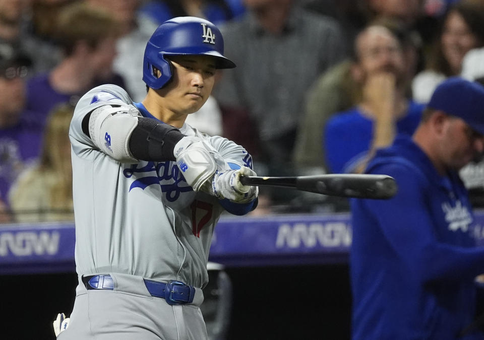 Los Angeles Dodgers' Shohei Ohtani takes a swing before stepping into the batter's box to face Colorado Rockies relief pitcher Jake Bird in the eighth inning of a baseball game Wednesday, June 19, 2024, in Denver. (AP Photo/David Zalubowski)