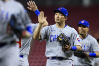 Chicago Cubs' Seiya Suzuki high-fives teammates after the final out of a baseball game against the Cincinnati Reds in Cincinnati, Tuesday, May 24, 2022. The Cubs won 11-4. (AP Photo/Aaron Doster)