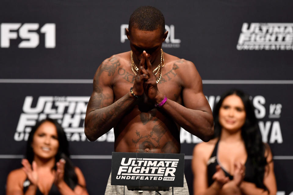 Israel Adesanya poses on the scale during The Ultimate Fighter Finale weigh-in inside The Pearl concert theater at Palms Casino Resort. (Getty Images)