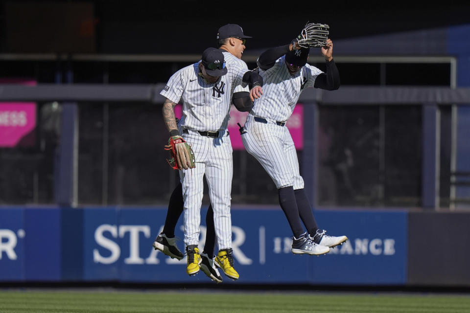 New York Yankees' Alex Verdugo, left, Aaron Judge, center, and Juan Soto, right, celebrate after a baseball game against the Toronto Blue Jays Sunday, April 7, 2024, in New York. The Yankees won 8-3. (AP Photo/Frank Franklin II)