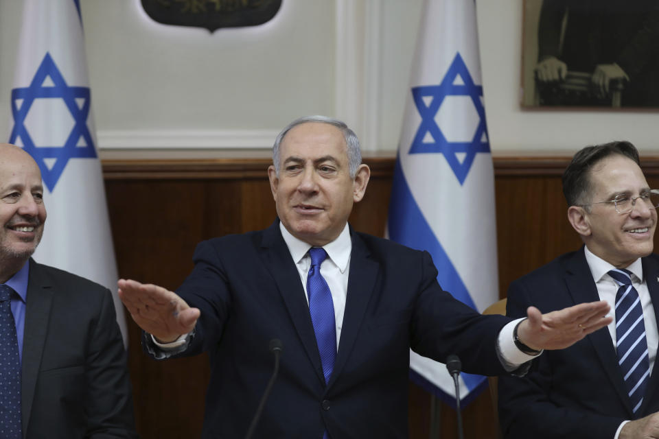 Israeli Prime Minister Benjamin Netanyahu, center, Minister for Regional Cooperation Tzachi Hanegbi, left, and Cabinet Secretary Tzahi Braverman attend the weekly cabinet meeting at the prime minister's office in Jerusalem, Israel, Sunday, Dec. 29, 2019. (Abir Sultan /Pool photo via AP)