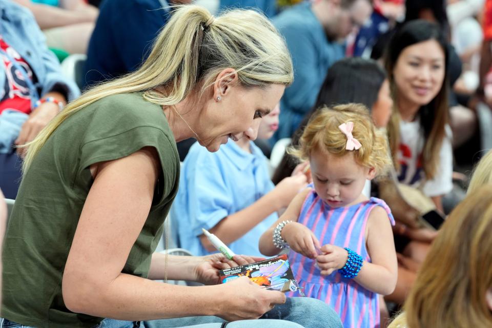 Former pro basketball player Penny Taylor entertains her young children, Isla and Leo, while watching wife Diana Taurasi compete for Team USA against Japan in the Paris 2024 Olympic Summer Games at Stade Pierre-Mauroy.