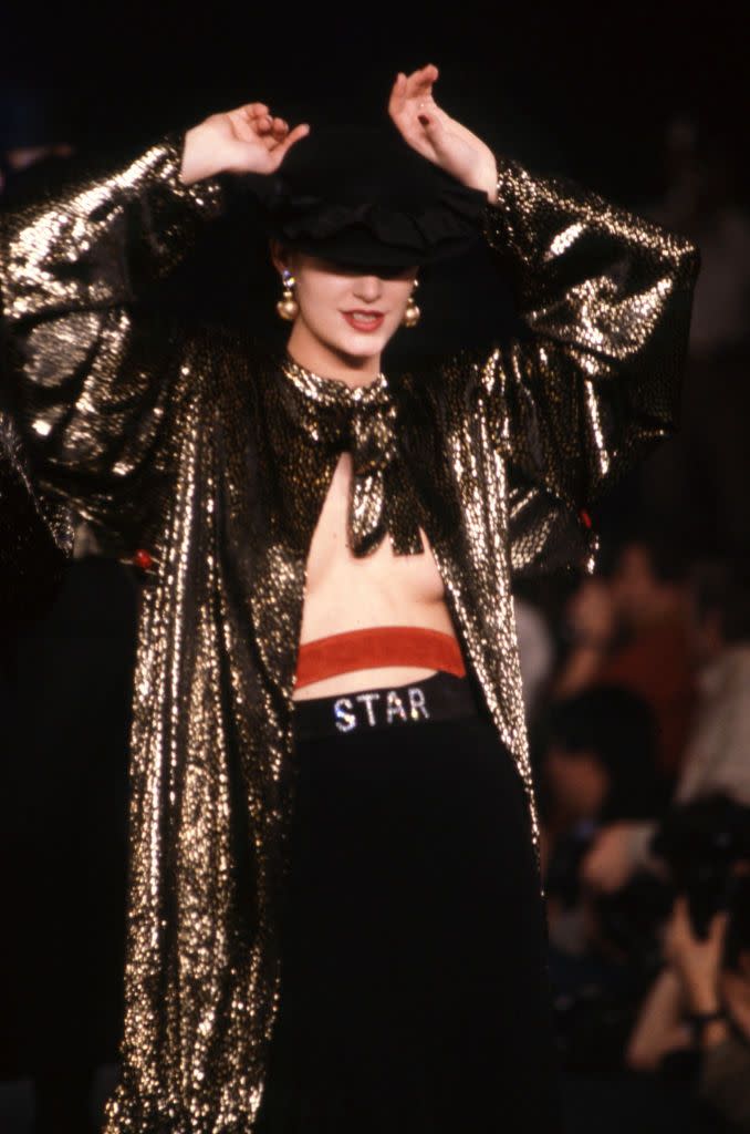 <p>A model poses on the runway in a gold sequined top and trousers at the Sonia Rykiel spring 1983 fashion show. </p>