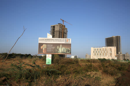 A billboard stands in front of buildings under construction at the Gujarat International Finance Tec-City (GIFT) at Gandhinagar, in the western state of Gujarat, March 20, 2019. REUTERS/Amit Dave