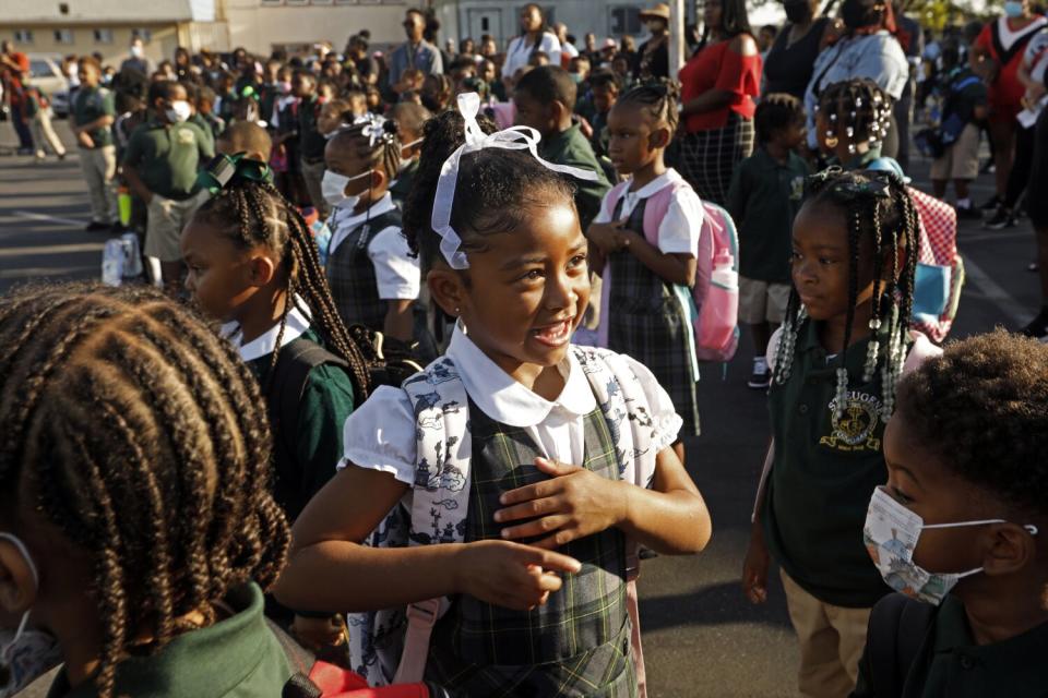 A 4-year-old girl is all smiles on her first day of school