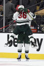 Minnesota Wild right wing Mats Zuccarello (36) and left wing Marcus Foligno celebrate their overtime victory over the Vegas Golden Knights in Game 1 of a first-round NHL hockey playoff series Sunday, May 16, 2021, in Las Vegas. (AP Photo/David Becker)