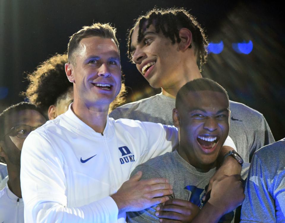 Duke coach Jon Scheyer hugs guard Jaylen Blakes during Countdown to Craziness at Cameron Indoor Stadium.