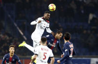 Guingamp's Marcus Thuram, top, jumps for the ball with PSG's Dani Alves during the League One soccer match between Paris Saint Germain and Guingamp at the Parc des Princes stadium in Paris, Saturday, Jan. 19, 2019. (AP Photo/Michel Euler)