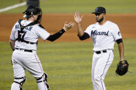 Miami Marlins catcher Chad Wallach (17) shakes hands with relief pitcher Yimi Garcia after a baseball game against the Arizona Diamondbacks, Thursday, May 6, 2021, in Miami. (AP Photo/Lynne Sladky)