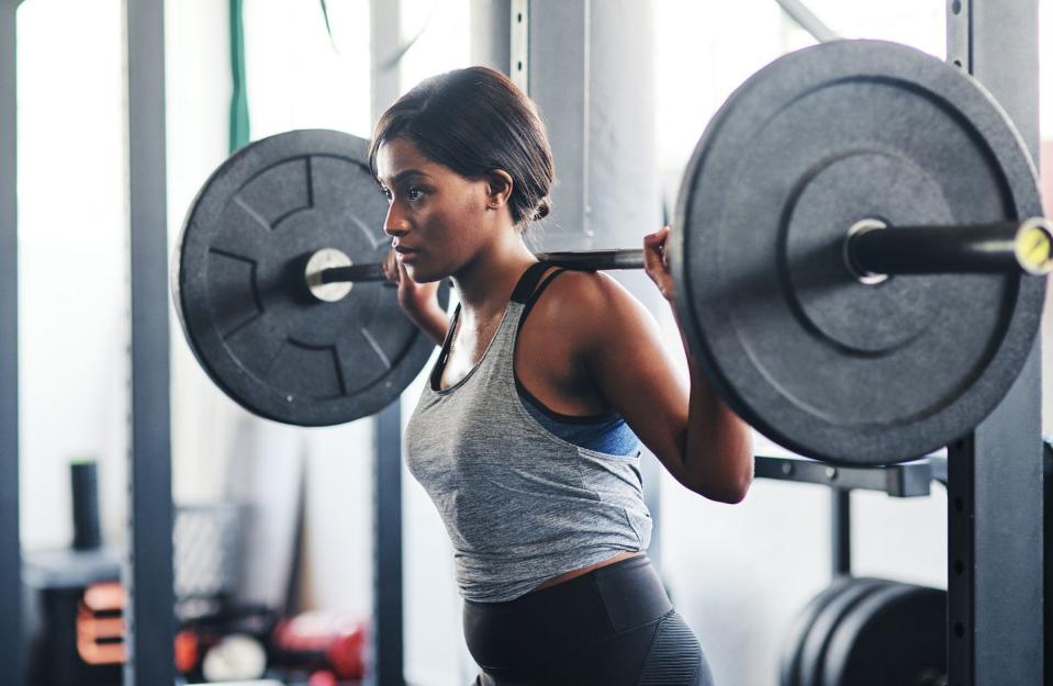 a woman lifting a heavy looking weight