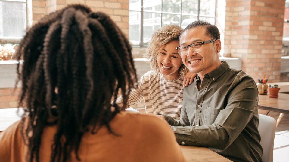 Couple talk with financial advisor.