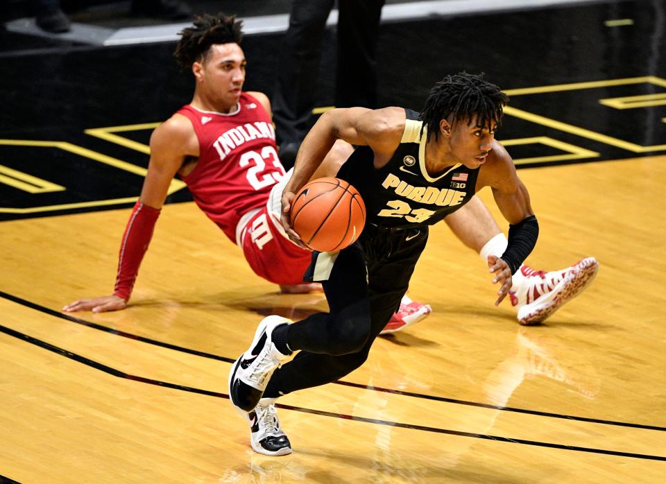 Purdue Boilermakers guard Jaden Ivey (23) dribbles the ball away from a downed Indiana Hoosiers forward Trayce Jackson-Davis (23) during the first half of the game at Mackey Arena.