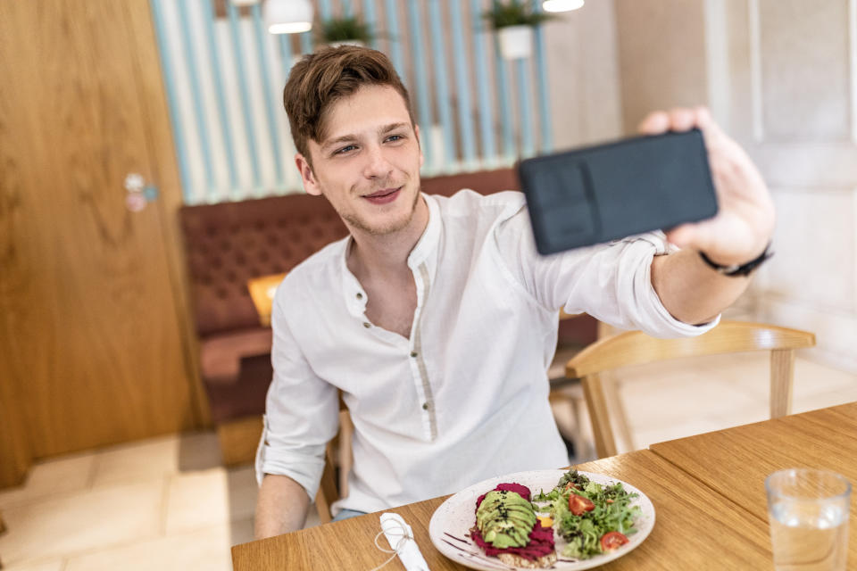 person taking a selfie with their food