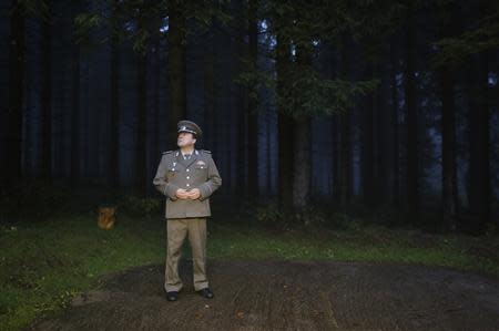 Thomas Krueger dressed as a NVA major waits outside the 'Bunker-Museum' in Rennsteighoehe near the eastern city of Ilmenau October 12, 2013. REUTERS/Ina Fassbender