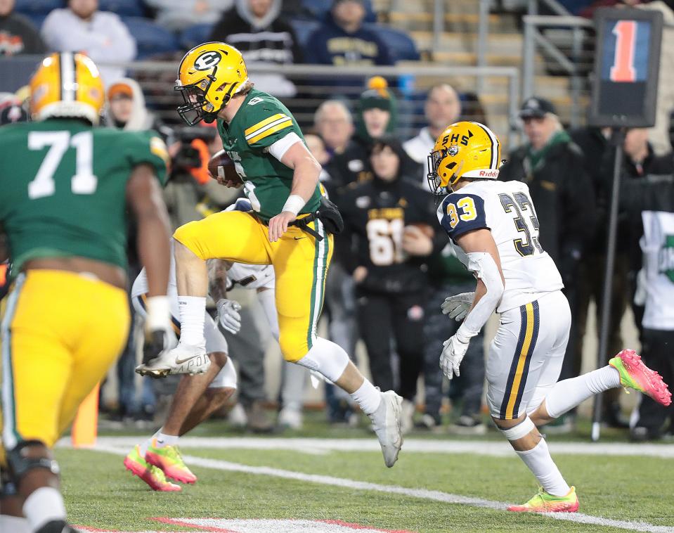 St. Edward quarterback Casey Bullock leaps into the end zone for a first-half touchdown during the Division I state championship game at Tom Benson Hall of Fame Stadium in Canton, Friday, Dec. 2, 2022.