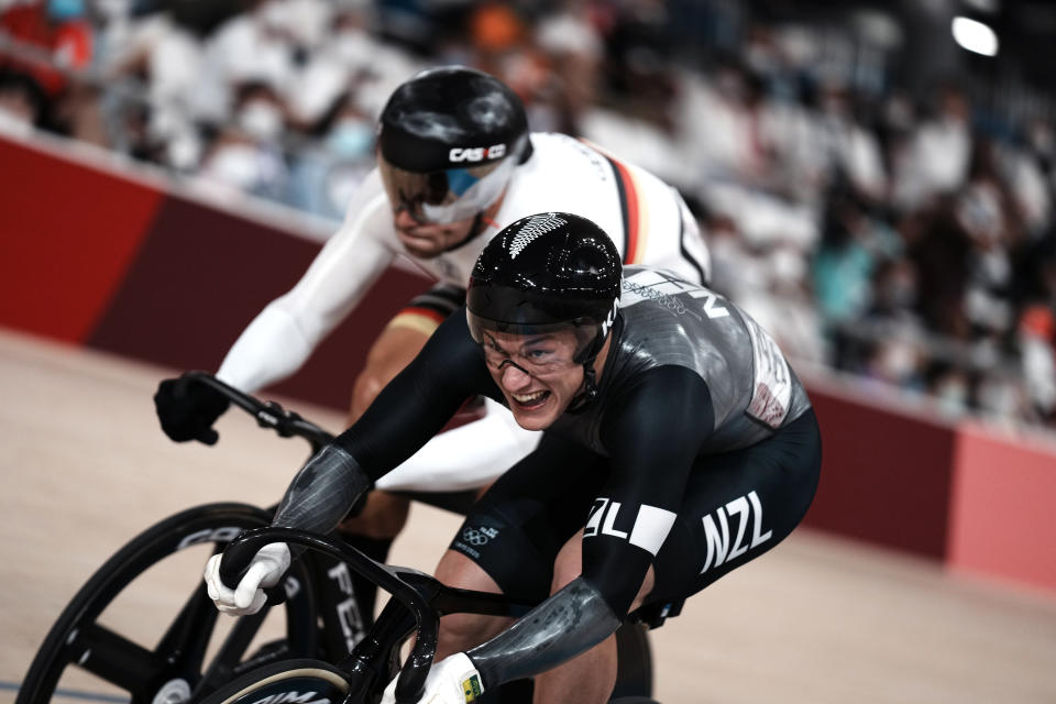 Sam Webster of Team New Zealand and Maximilian Levy of Team Germany, behind, compete during the track cycling men's sprint race at the 2020 Summer Olympics, Thursday, Aug. 5, 2021, in Izu, Japan. (AP Photo/Thibault Camus)