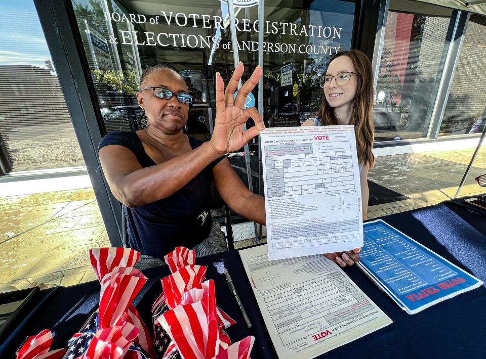 Carolyn Williams, left, Election Clerk holds a form for voter registration near Carissa Smith, voter services supervisor, in the booth outside the Anderson County Board of Voter Registration and Elections office in downtown Anderson, SC Tuesday, September 20, 2022.