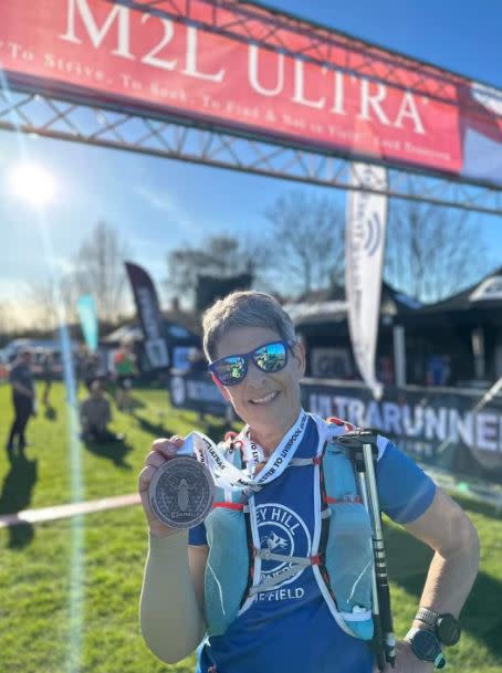 Judith Kippax at the finish line of the Manchester to Liverpool Ultra 50