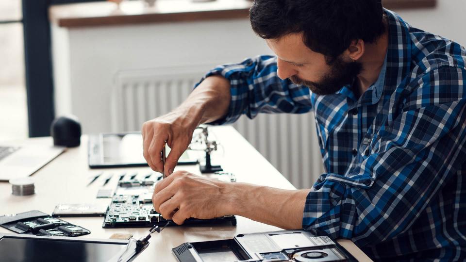 man refurbishing computer product