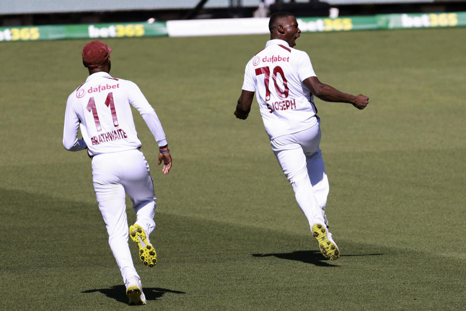 West Indies' Shamar Joseph, right, celebrates taking the wicket of Australia's Steve Smith on the first day of their cricket test match in Adelaide, Australia, Wednesday, Jan. 17, 2024. (AP Photo/James Elsby)