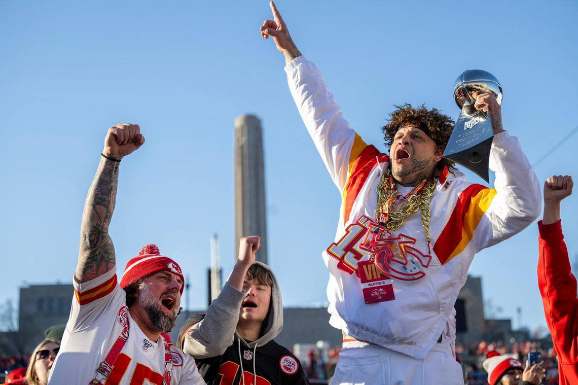 Chiefs fans Blair Falconer, left, of Overland Park, and Scott Shepard, right, of Kansas City, cheered on the Chiefs before the Super Bowl LVIII championship parade and rally on Wednesday, Feb. 14, 2024, in Kansas City. Falconer won the replica Lombardi trophy in a raffle. Tammy Ljungblad/tljungblad@kcstar.com