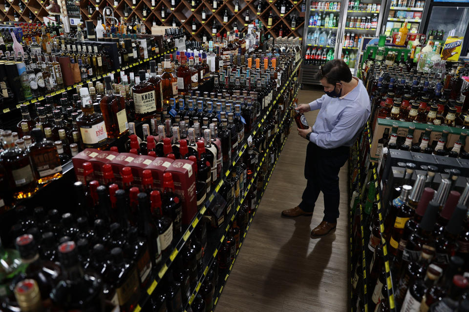 MIAMI, FLORIDA - FEBRUARY 03: Ramon Baez shops for bourbon at Jensen's Liquors on February 03, 2021 in Miami, Florida. The Distilled Spirits Council reported that U.S. distillers’ revenue grew 7.7% to $31.2 billion last year, marking the fastest growth and highest sales for at least 40 years. Alcohol that sold for above $40 per 750 milliliters accounted for 40% of the U.S. spirits industry’s growth in 2020, compared with 34% in 2019. (Photo by Joe Raedle/Getty Images)