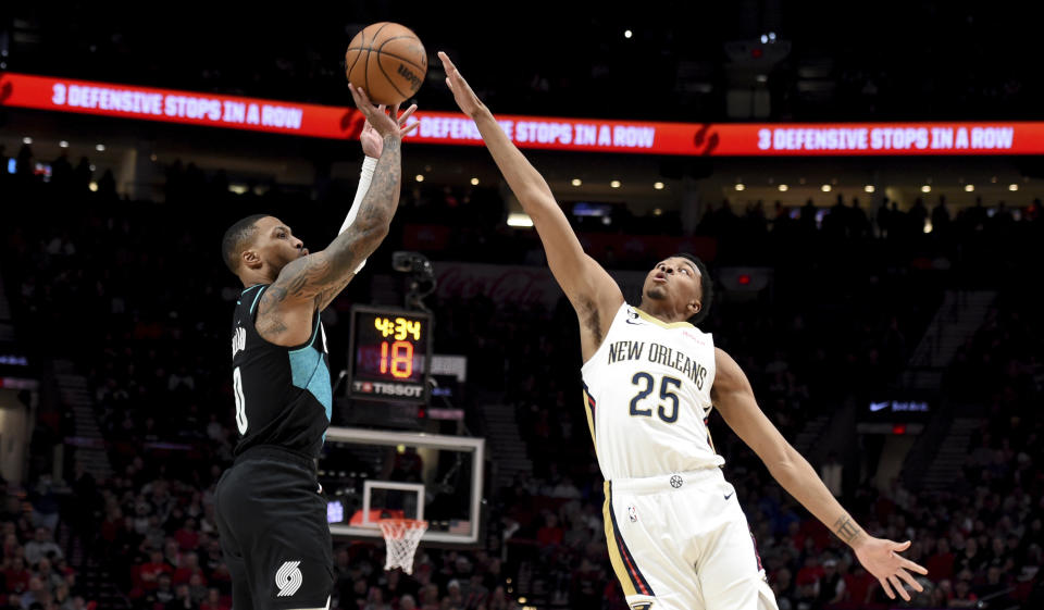 Portland Trail Blazers guard Damian Lillard, left, shoots over New Orleans Pelicans guard Trey Murphy III during the first half of an NBA basketball game in Portland, Ore., Wednesday, March 1, 2023. (AP Photo/Steve Dykes)