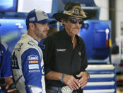 FILE - In this July 29, 2016, file photo, racing legend Richard Petty, right, stands with Jimmie Johnson (48) in the garage area of Pocono Raceway during practice for the NASCAR Sprint Cup Series Pennsylvania 400 auto race in Long Pond, Pa. Seven-time NASCAR champion Jimmie Johnson says 2020 will be his final season of full-time racing. The winningest driver of his era will have a 19th season in the No. 48 Chevrolet and once again chase a record eighth championship. Johnson made the announcement in a video posted on social media, Wednesday, Nov. 20, 2019. (AP Photo/Mel Evans, File)