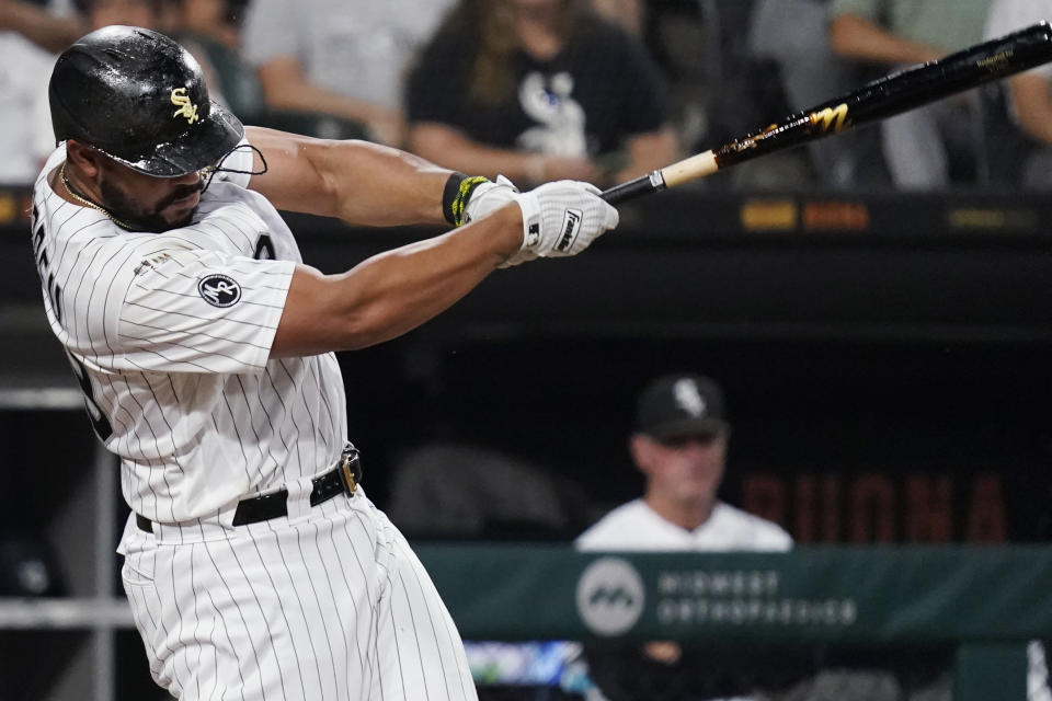Chicago White Sox's Jose Abreu hits an RBI single during the first inning of the team's baseball game against the Chicago Cubs in Chicago, Friday, Aug. 27, 2021. (AP Photo/Nam Y. Huh)