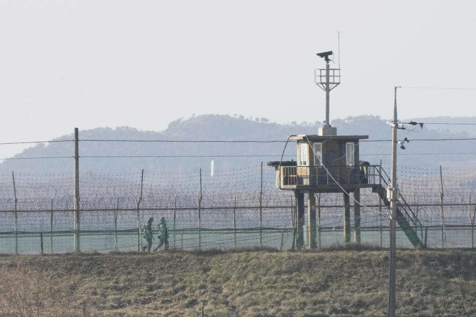 South Korean army soldiers patrol along the barbed-wire fence in Paju, near the border with North Korea, South Korea, Sunday, Jan. 2, 2022. South Korea's military said Sunday that an unidentified person crossed the heavily fortified border into North Korea. (AP Photo/Ahn Young-joon)