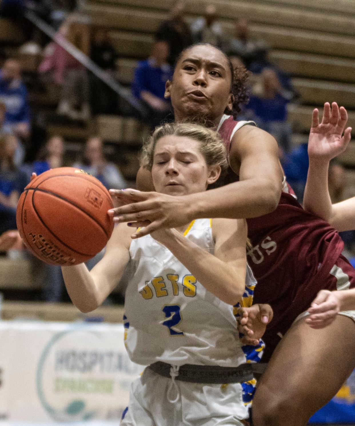 Mikaiya Beasley of Albertus Magnus fights Kayla Lederer of East Meadow for a rebound in a New York State girls Class AA basketball semifinal at Hudson Valley Community College in Troy March 15, 2024. Albertus Magnus defeated East Meadow 89-51 to advance to the Class AA final on Saturday.