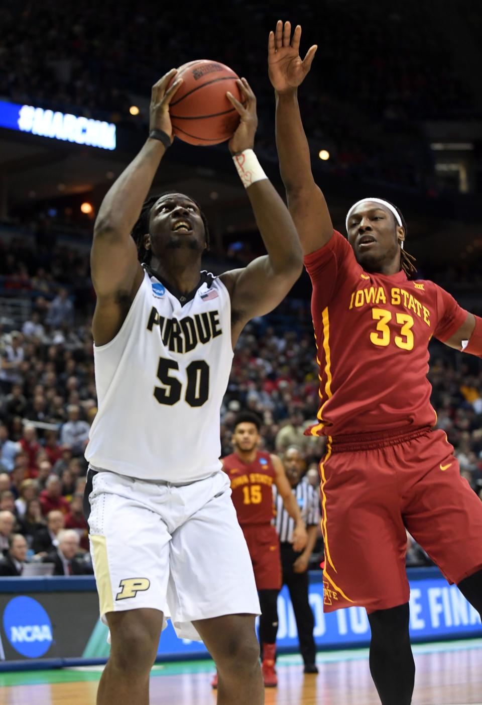 Purdue Boilermakers forward Caleb Swanigan (50) goes up for a shot while Iowa State Cyclones forward Solomon Young (33) defends during the first half of the game in the second round of the 2017 NCAA Tournament at BMO Harris Bradley Center.