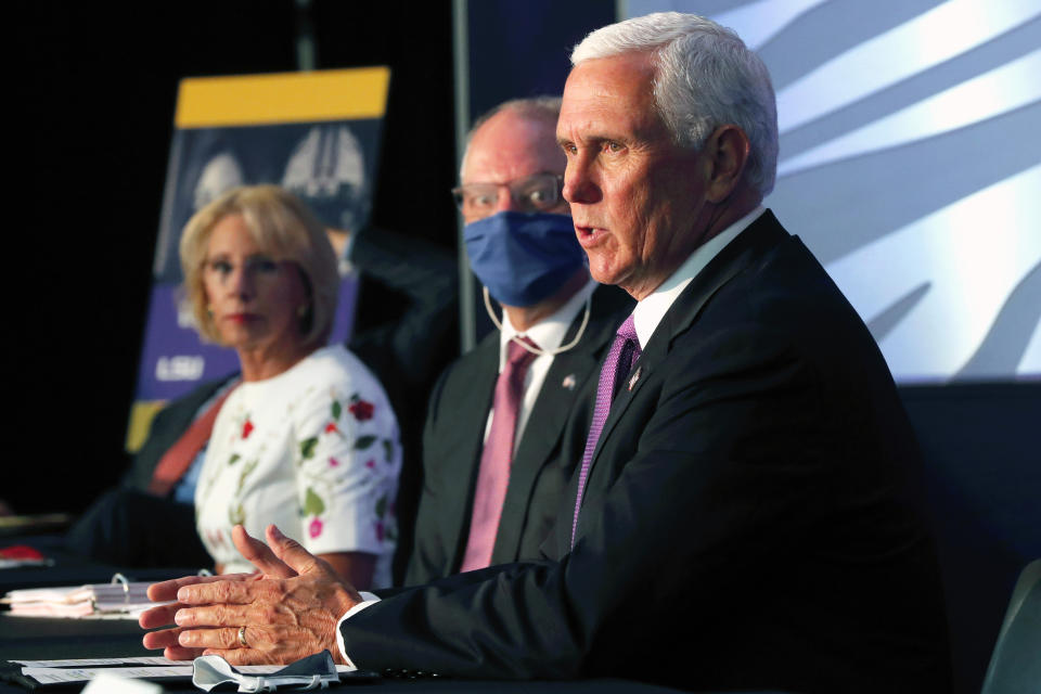 Education Secretary Betsy DeVos listens with Louisiana Gov. John Bel Edwards as Vice President Mike Pence speaks at a roundtable discussion in Tiger Stadium on the LSU campus in Baton Rouge, La., Tuesday, July 14, 2020. (AP Photo/Gerald Herbert)