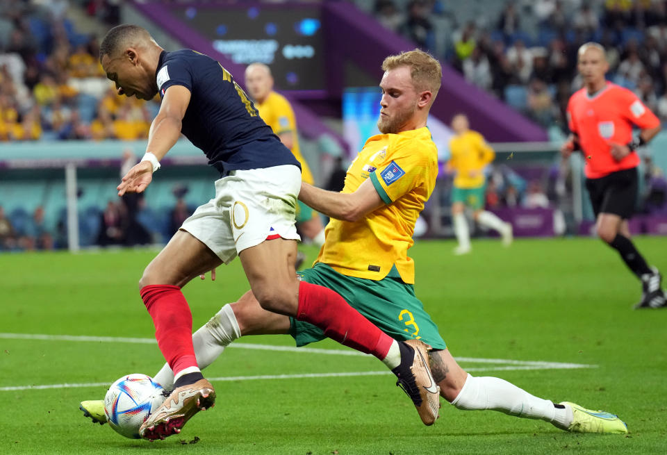 Seen here, France's Kylian Mbappe is tackled by Australia's Nathaniel Atkinson at the 2022 FIFA World Cup.