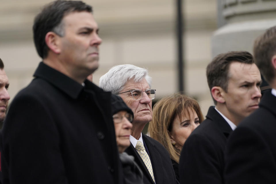 Former Mississippi Gov. Phil Bryant, center, joins current Mississippi Secretary of State Michael Watson, left, and Mississippi State Auditor Shad White, right, during the inauguration of Republican Gov. Tate Reeves in Jackson, Miss., Tuesday, Jan. 9, 2024, at the Mississippi State Capitol. (AP Photo/Rogelio V. Solis)