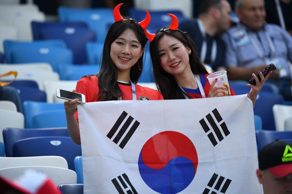 <p>South Korea supporters wave the national flag ahead of the Russia 2018 World Cup Group F football match between Sweden and South Korea at the Nizhny Novgorod Stadium in Nizhny Novgorod on June 18, 2018. (Photo by Johannes EISELE / AFP) </p>