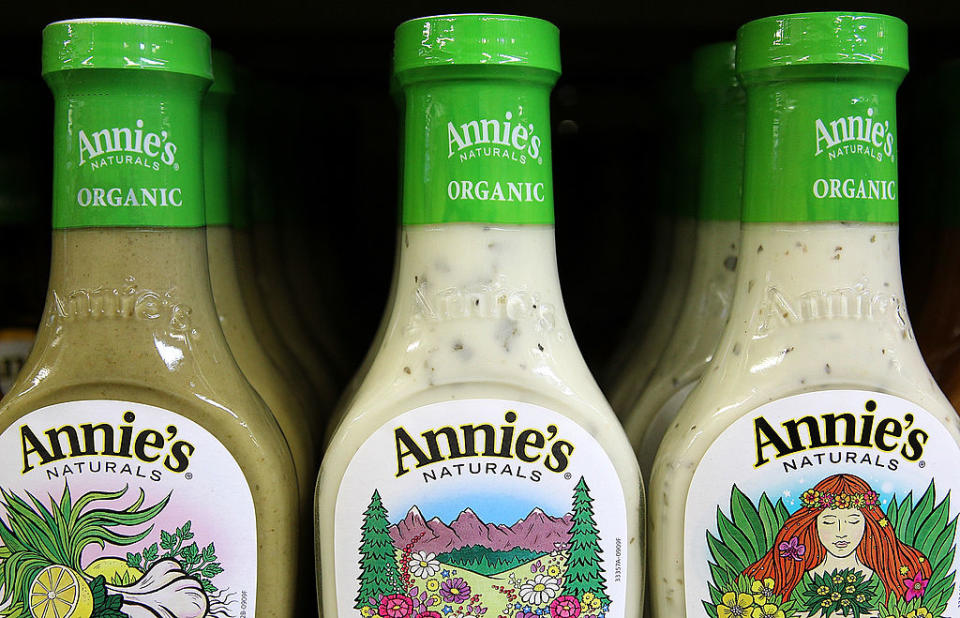 Three bottles of Annie's Organic salad dressing on a shelf