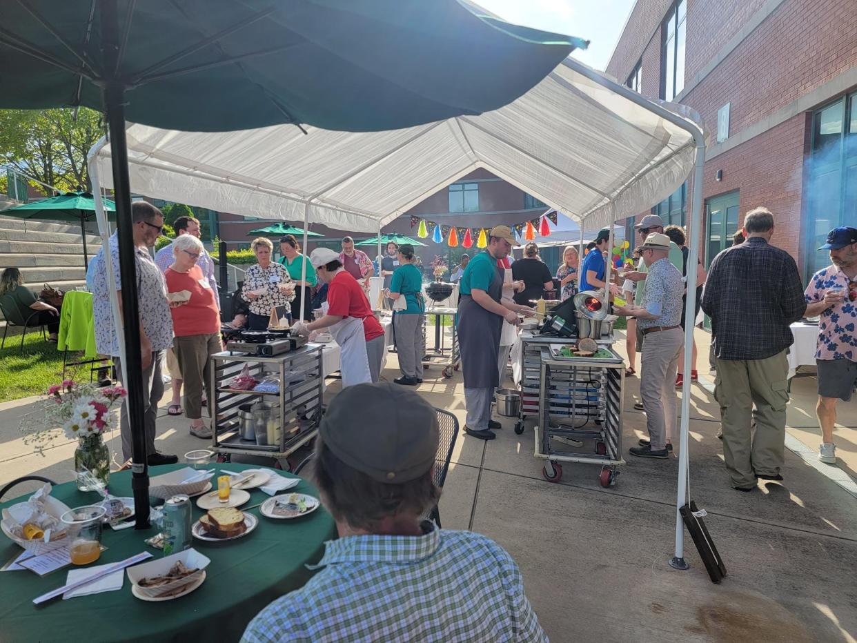 Ivy Tech students work food stations at the 2023 Hospitality Showcase. In the middle forefront, right, is Dalton Strunk (graduating May 2024), at left is Riley Burris (graduate class of 2023), and Claire Vesyoly (graduating this May) is seen back left.